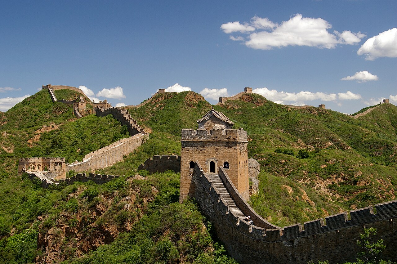 A watchtower on the Great Wall at Jinshanling, with the wall running on across green hills